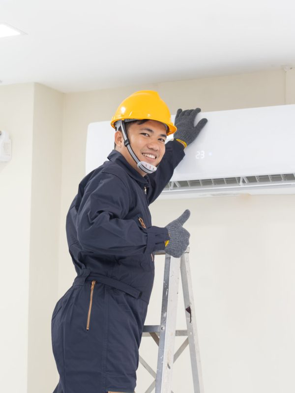 The mechanic Technician are Repairing Air Conditioner in room.